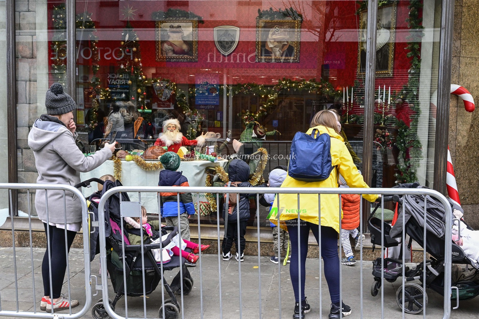 People stop to see the festive window display at Fenwicks on Northumberland Street in Newcastle upon Tyne on Black Friday