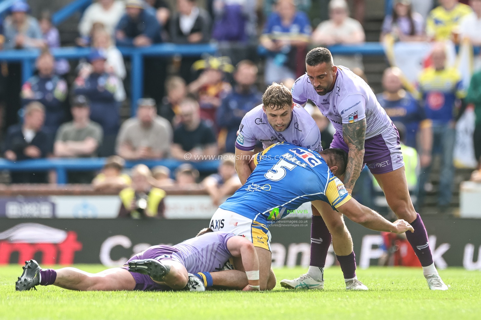Ryan Hall of Leeds Rhinos is tackled by Luke Yates of Warrington Wolves Sam Powell of Warrington Wolves and Paul Vaughan of Warrington Wolves during the Betfred Super League Round 14 Leeds Rhinos v Warrington Wolves at Headingley Stadium, Leeds, United Kingdom, 14th June 2025

(Photo by Mark Cosgrove/News Images)
