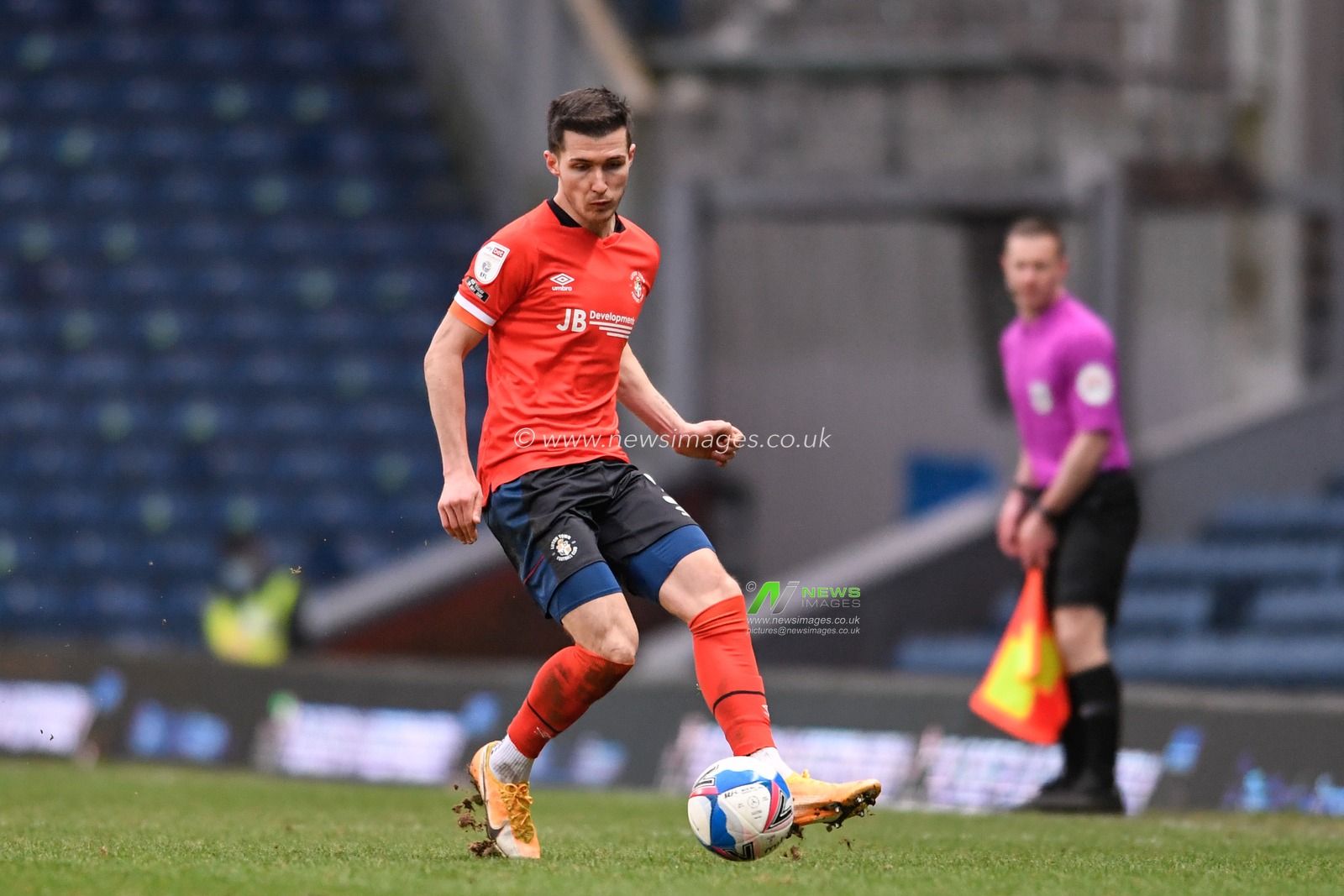 Dan Potts #3 of Luton Town passes the ball