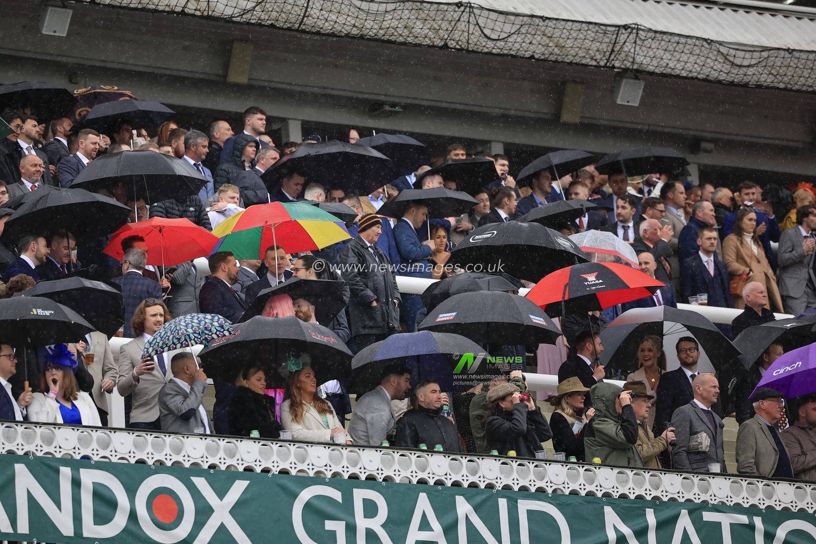 Racegoers sheltering from the rain during the Randox Grand National festival 2023 Ladies Day at Aintree Racecourse, Liverpool, United Kingdom, 14th April 2023

(Photo by Conor Molloy/News Images)