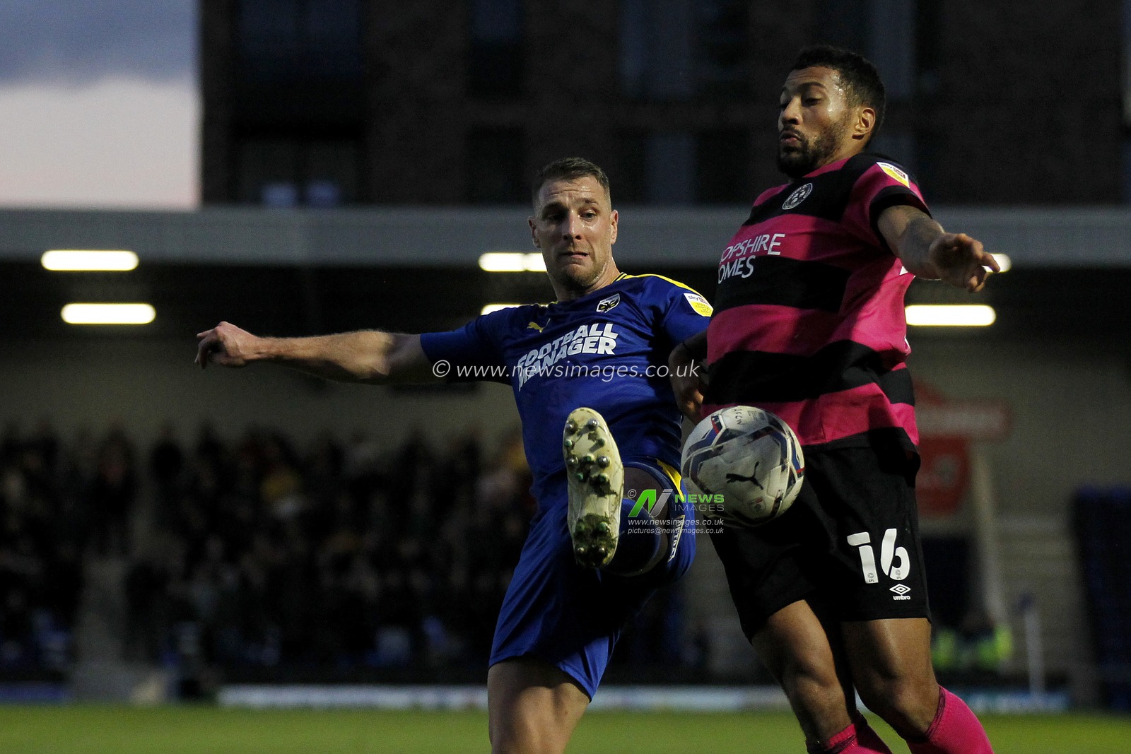 David Davis #16 of Shrewsbury Town defends against Lee Brown of #55 of AFC Wimbledon