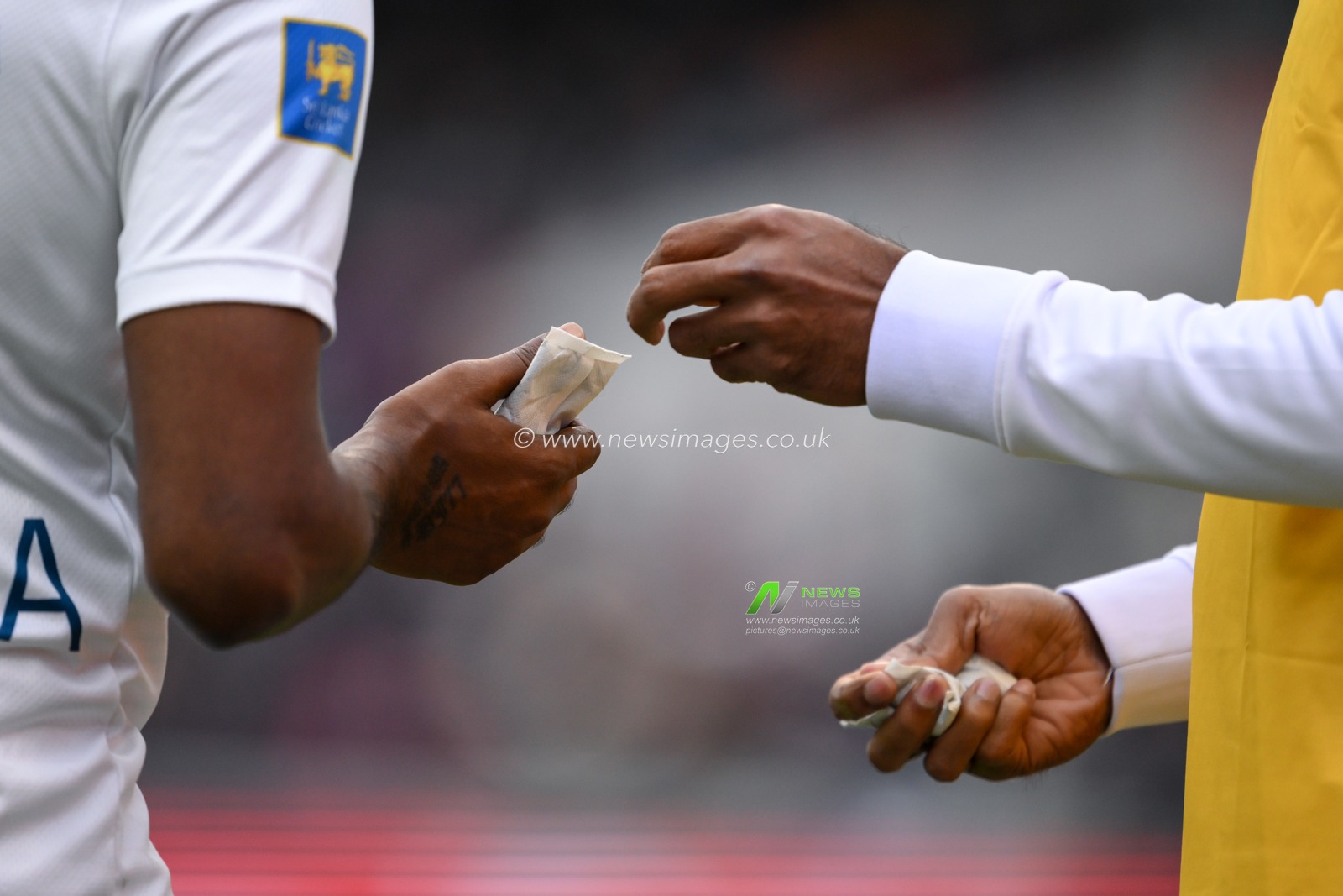 Prabath Jayasuriya of Sri Lanka is given hand warmers has the temperature lowers during the England Men v Sri Lanka 1st Rothesay Test Match Day 2 at Old Trafford, Manchester, United Kingdom, 22nd August 2024

(Photo by Craig Thomas/News Images)