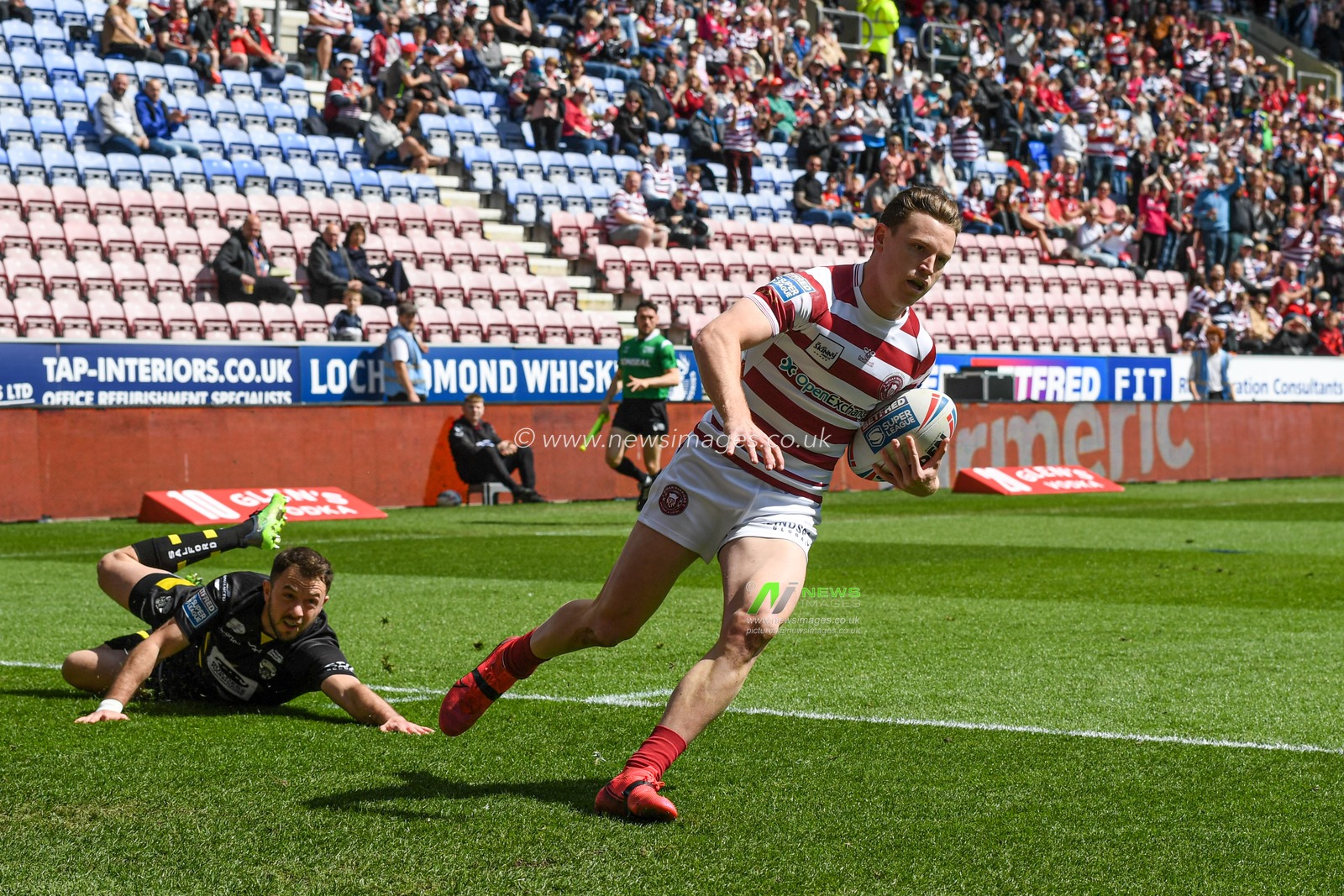 Jai Field #23 of Wigan Warriors goes over for a try to make it 0-4