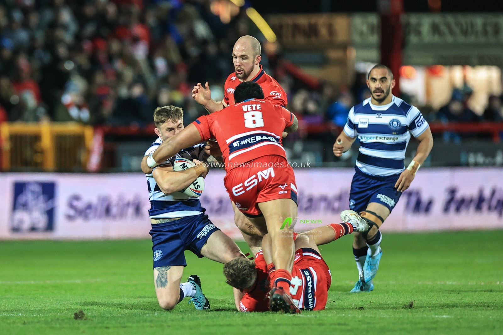 Sam Powell #9 of Wigan Warriors is tackled by Albert Vete #8 of Hull KR
