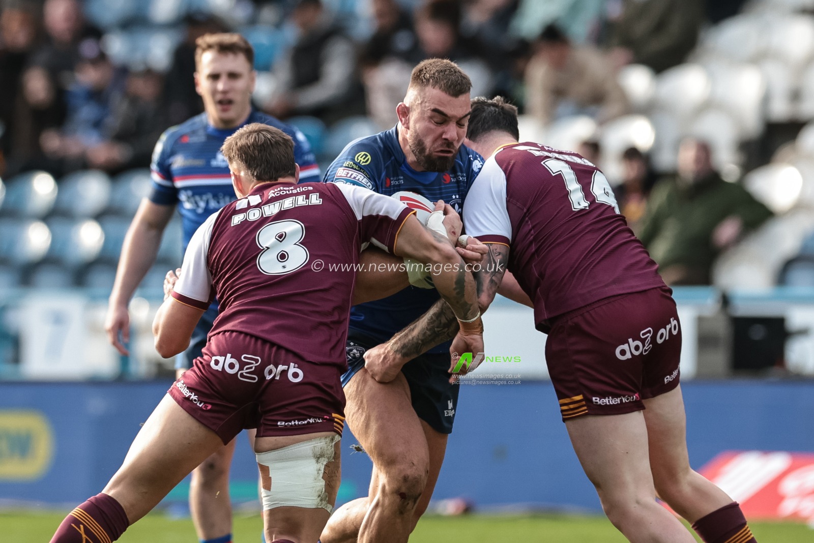 Mike McMeeken of Wakefield Trinity is tackled by Fenton Rogers of Huddersfield Giants and Tristan Powell of Huddersfield Giants during the Betfred Super League Round 2 match Huddersfield Giants vs Wakefield Trinity at Accu Stadium, Huddersfield, United Kingdom on 22 February 2026

(Photo by Mark Cosgrove/News Images)