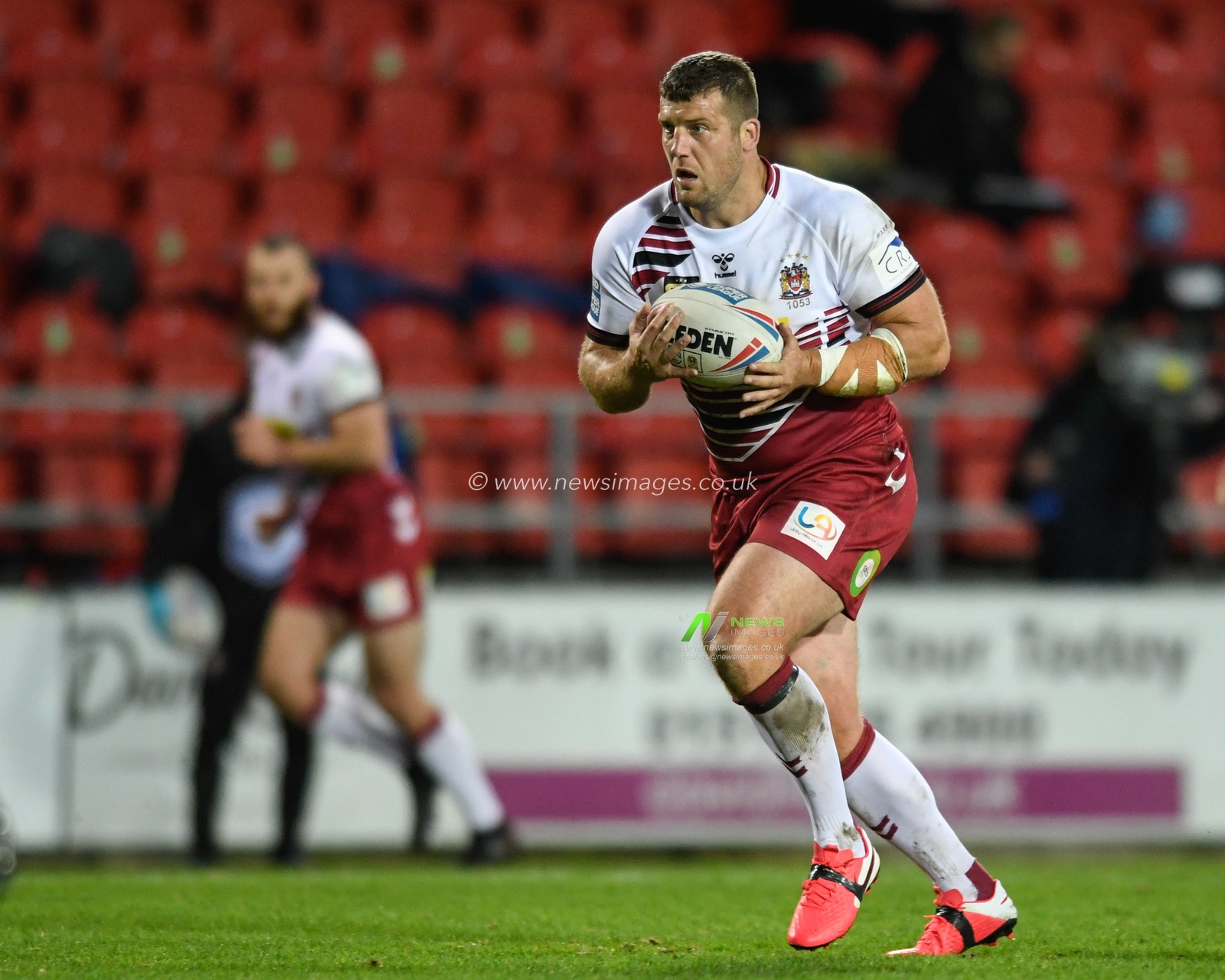 Tony Clubb (8) of Wigan Warriors runs forward with the ball