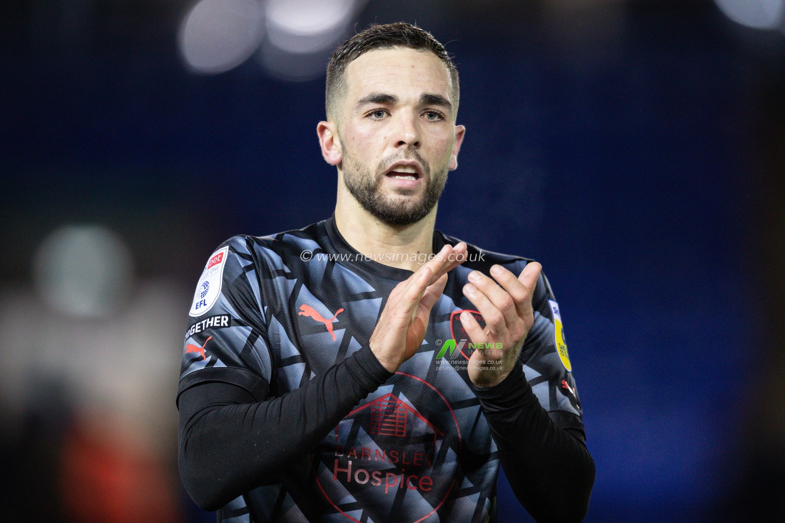 Goalscorer Adam Phillips #30 of Barnsley claps his hands and applauds the supporters at full-time after the Sky Bet League 1 match Peterborough vs Barnsley at Weston Homes Stadium, Peterborough, United Kingdom, 2nd December 2022

(Photo by James Heaton/News Images)
