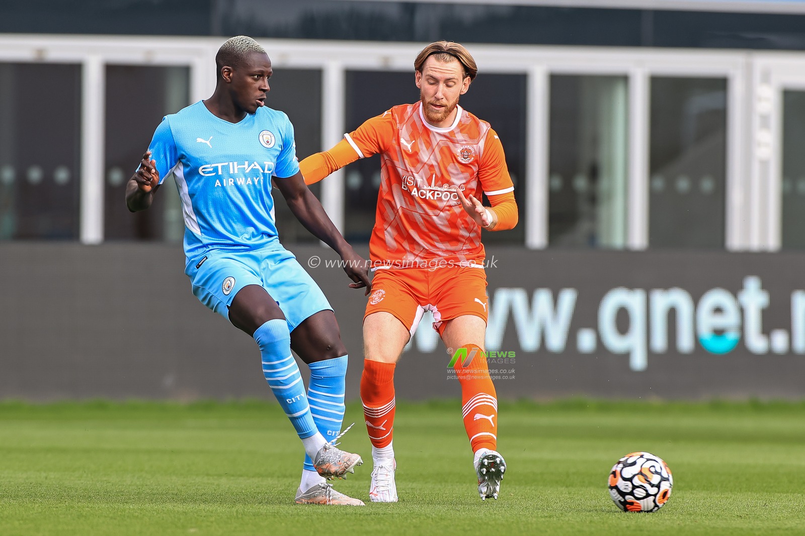 Benjamin Mendy #22 of Manchester City passes the ball as Josh Bowler of Blackpool pressures