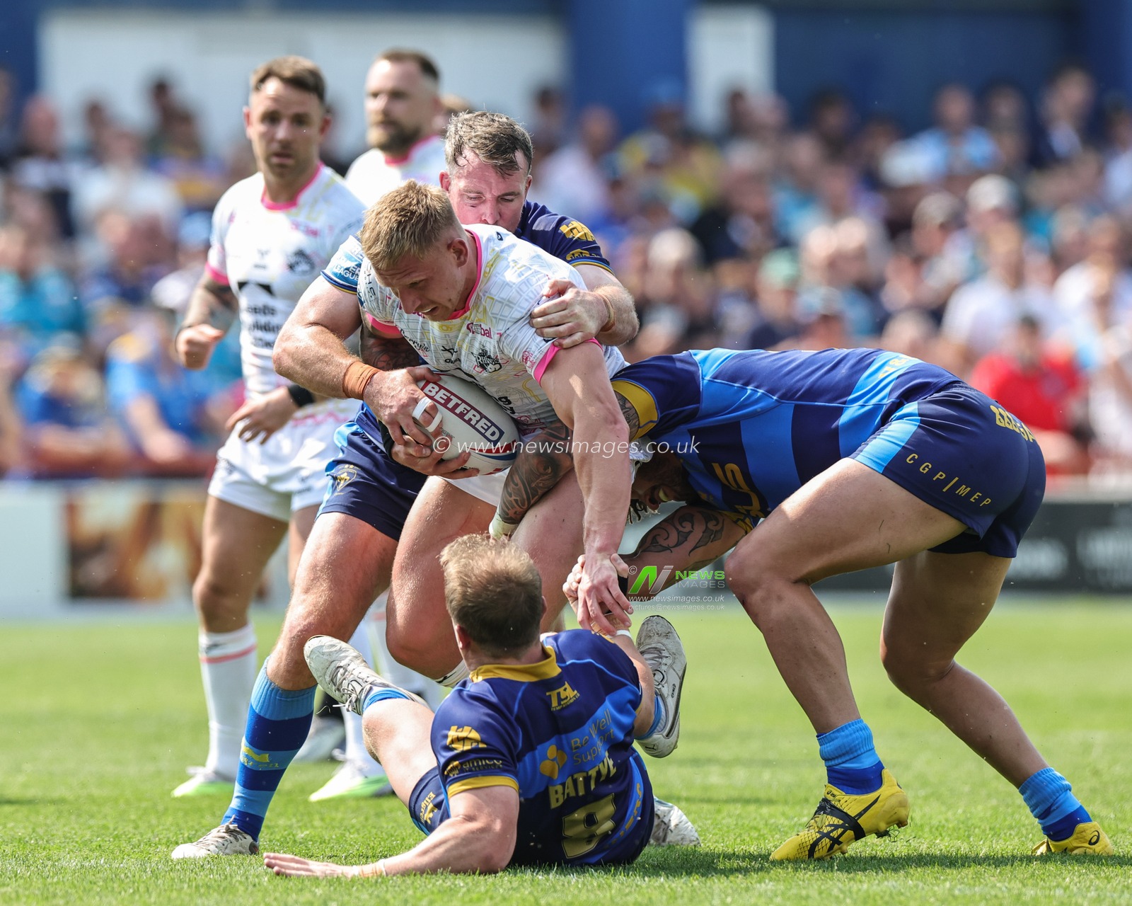 Mikolaj Oledzki #8 of Leeds Rhinos is tackled by Eddie Battye #8 of Wakefield Trinity during the Betfred Super League Round 15 match Wakefield Trinity vs Leeds Rhinos at The Be Well Support Stadium, Wakefield, United Kingdom, 11th June 2023

(Photo by Mark Cosgrove/News Images)