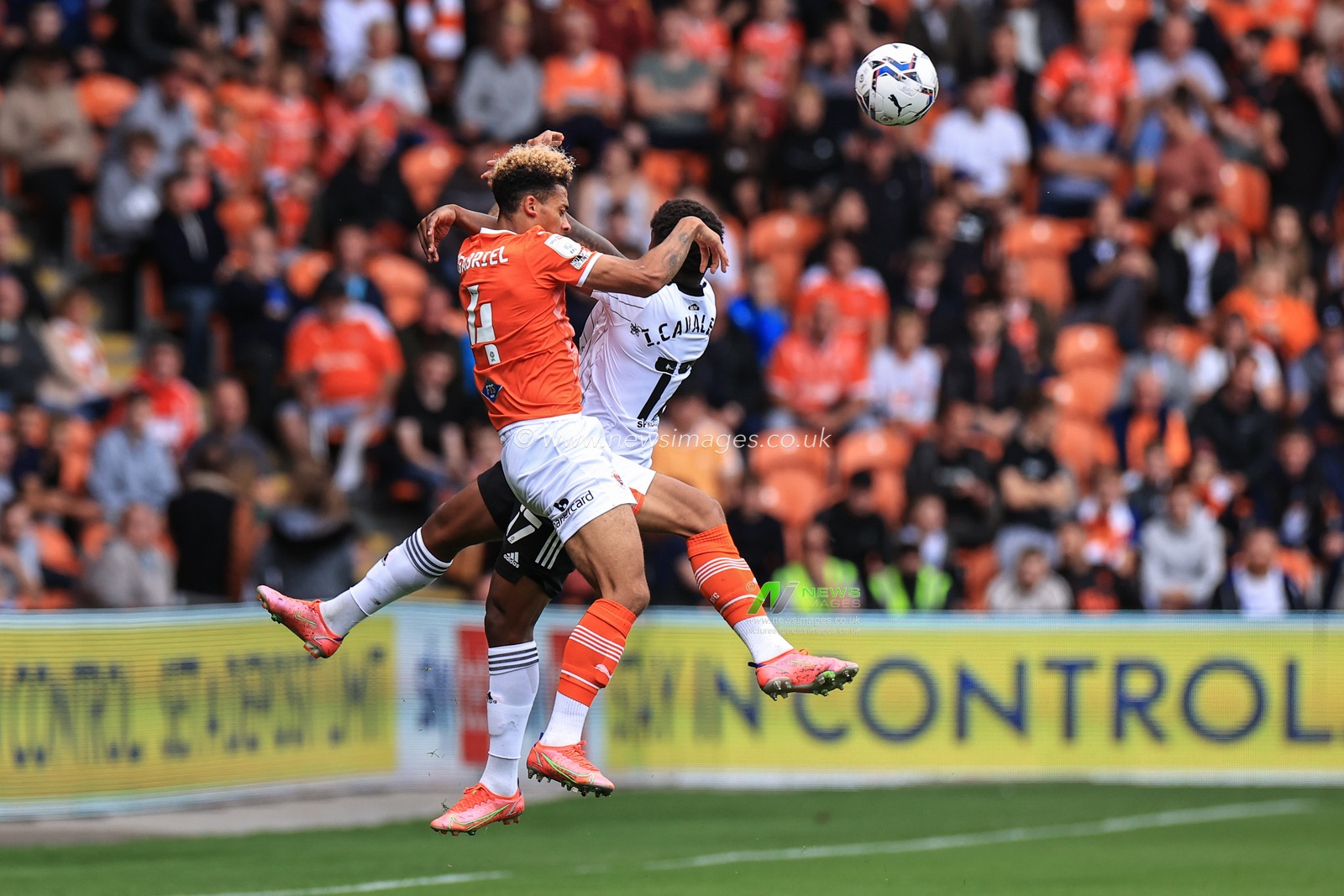 Jordan Gabriel #4 Of Blackpool and Ivan Cavaleiro #17 of Fulham battle for the ball