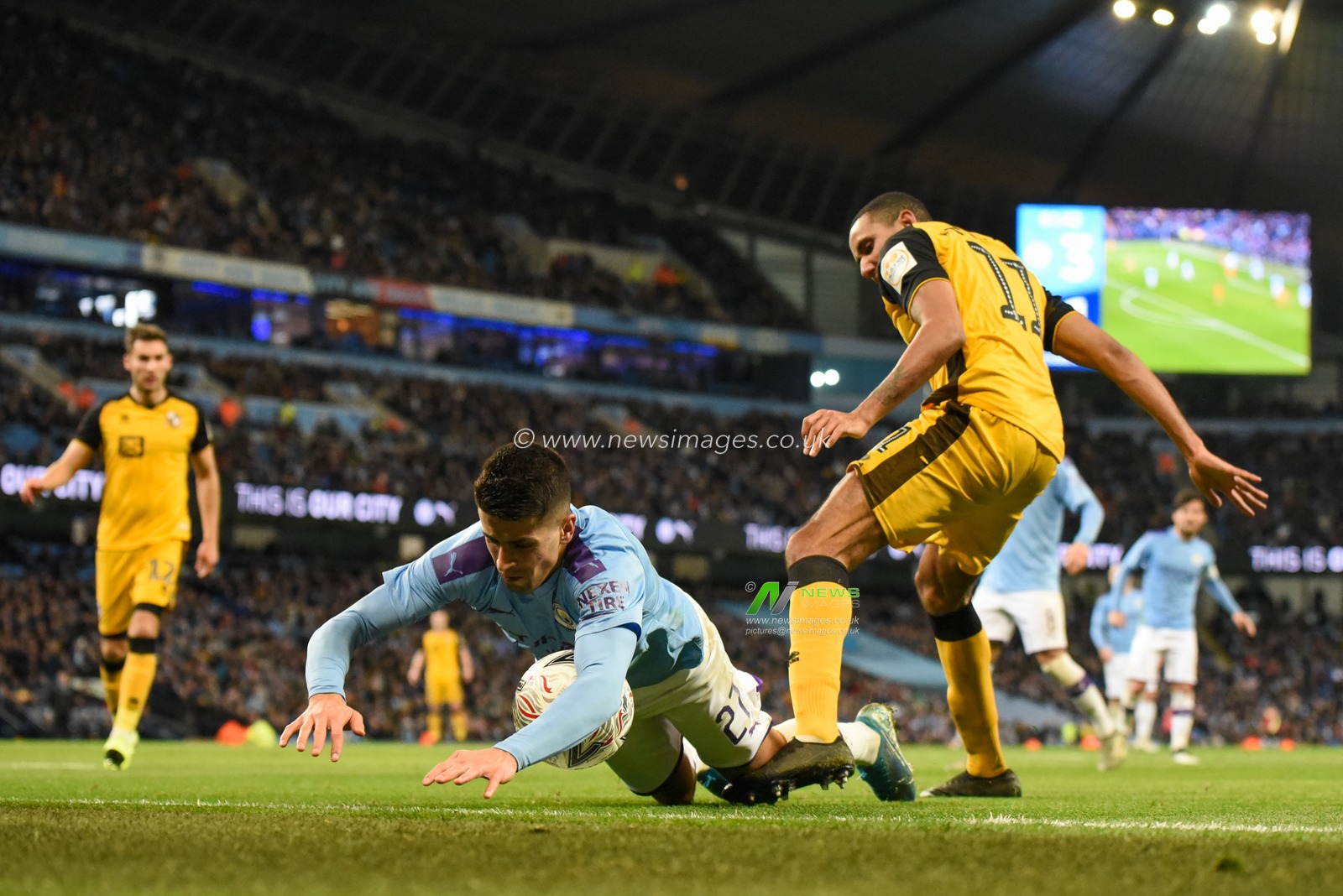 4th January 2020, Etihad Stadium, Manchester, England; Emirates FA Cup, Manchester City v Port Vale : Joao Cancelo (27) of Manchester City is fouled by Cristian Montano (11) of Port Vale

Credit: Simon Whitehead/News Images