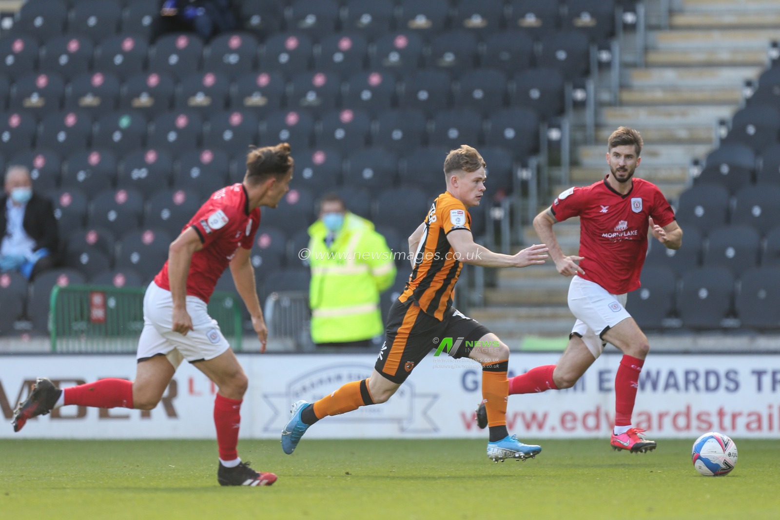 Keane Lewis-Potter (19) of Hull City gets through the defence