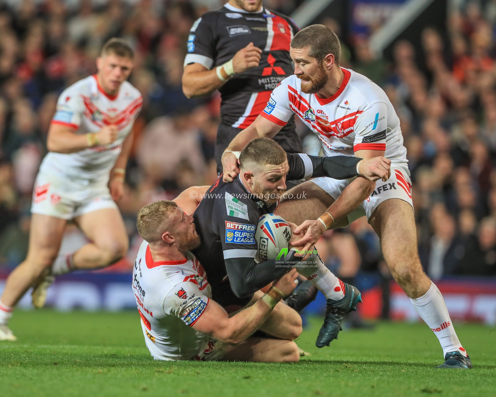 12th October 2019, Old Trafford, Manchester, England; The Grand Final 2019, Saint Helens v Salford Red Devils : Jackson Hastings (31) of Salford Red Devils is tackled by Luke Thompson (10) of St Helens and Kyle Amor (16) of St Helens 

Credit: Mark Cosgrove/News Images