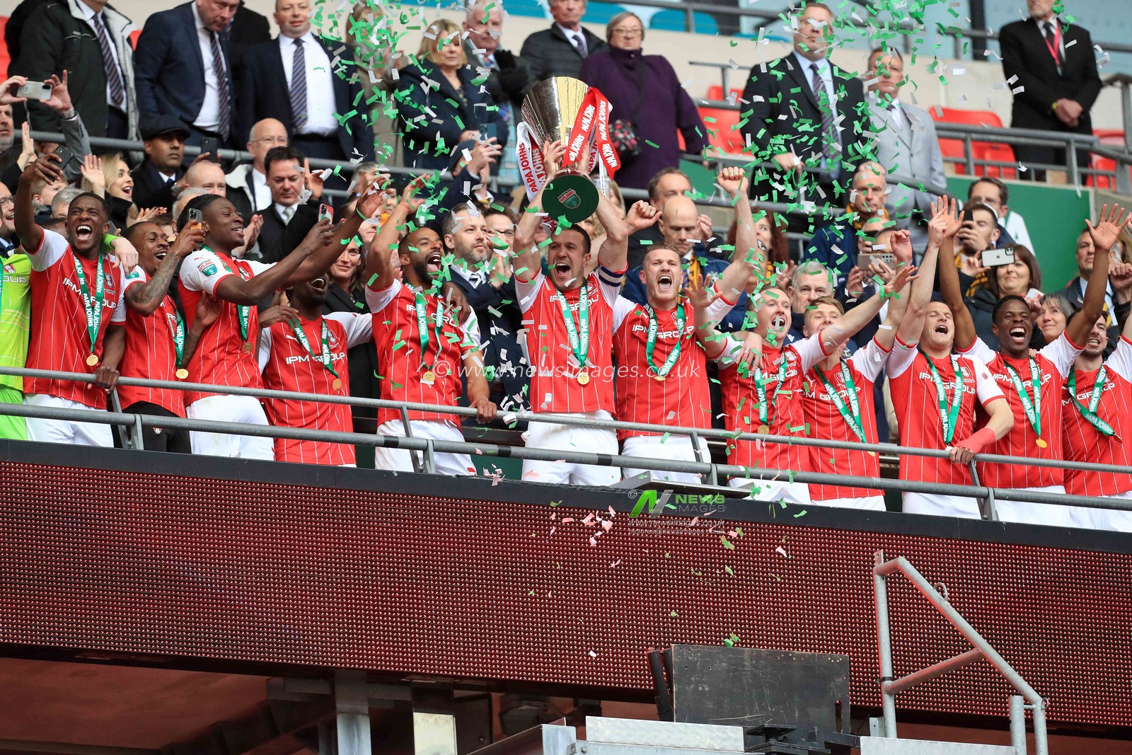 Richard Wood #6 of Rotherham United lifts the trophy.