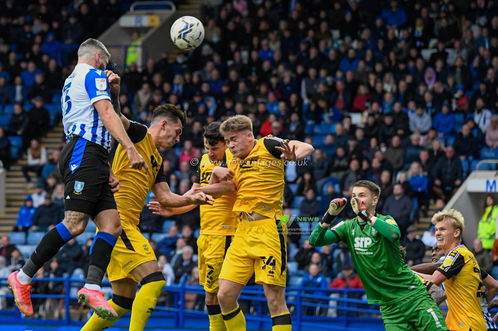 Callum Paterson #13 of Sheffield Wednesday heads the ball towards the goal