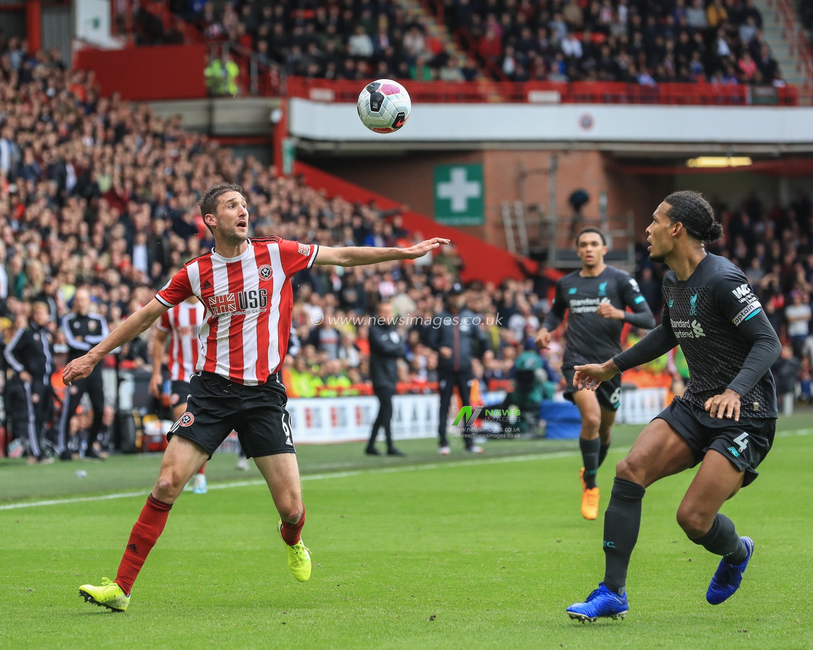28th September 2019, Bramall Lane, Sheffield, England; Premier League, Sheffield United v Liverpool : Chris Basham (6) of Sheffield United and Virgil van Dijk (4) of Liverpool look to gain possession 

Credit: Mark Cosgrove/News Images