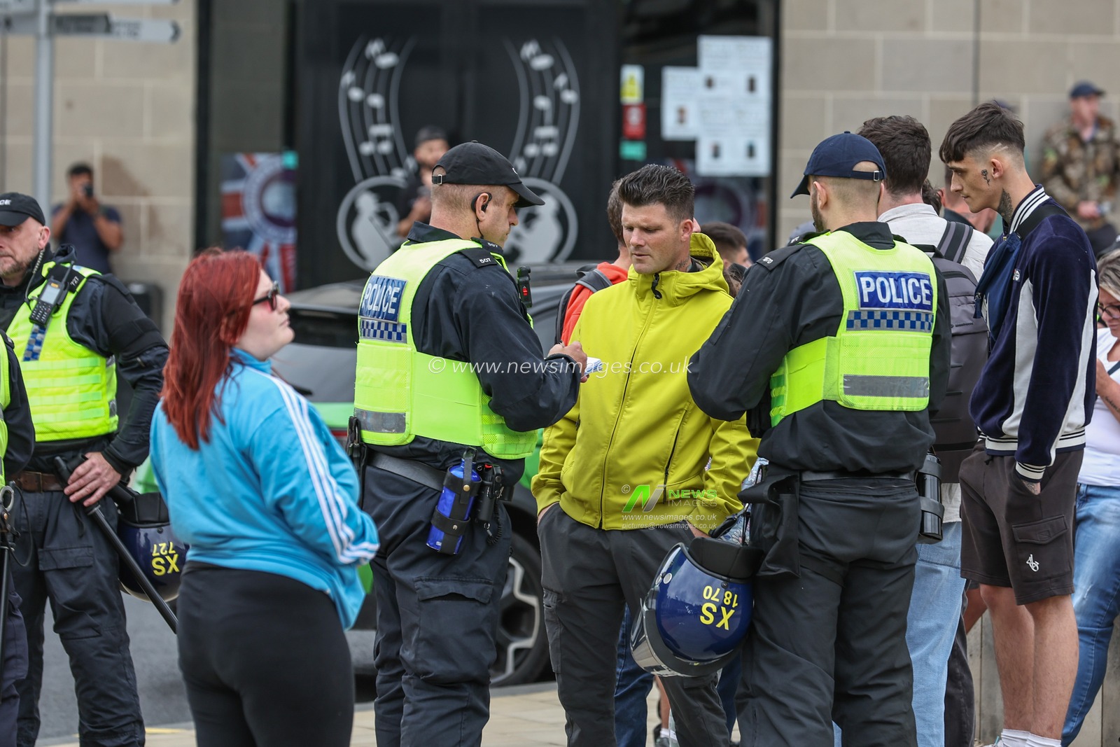 Police start taking details from people in the crowd as the demonstration continues during an anti-racism protest, Barnsley, United Kingdom, 8th August 2024