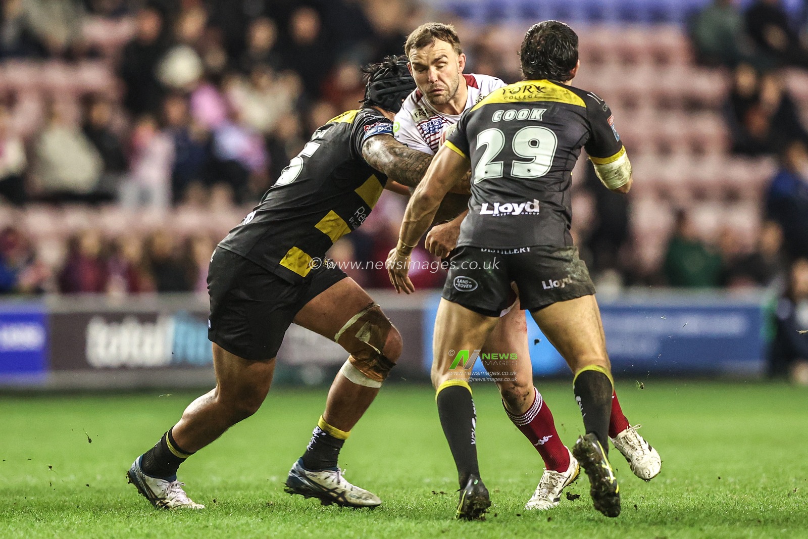Kaide Ellis of Wigan Warriors is tackled by Xavier Va'a of York Knights and Sam Cook of York Knights during the Betfred Super League round 5 match Wigan Warriors vs York Knights at The Brick Community Stadium, Wigan, United Kingdom on 19 March 2026

(Photo by Alfie Cosgrove/News Images)