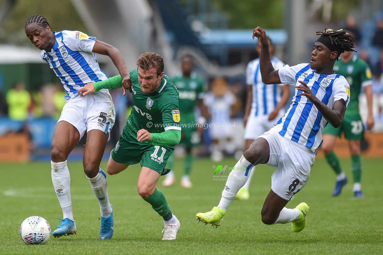 15th September 2019, John Smiths Stadium, Huddersfield England; Sky Bet Championship Football, Huddersfield Town vs Sheffield Wednesday ;Trevor Chalabah (8) of Huddersfield Town jumps into Sam Winnall (11) of Sheffield Wednesday as he fends off Terence Kongolo (5) of Huddersfield Town.

Credit: Dean Williams/News Images

English Football League images are subject to DataCo Licence