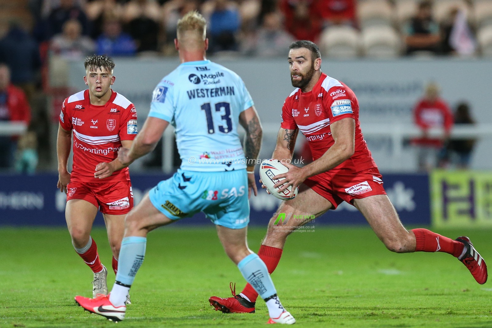 Kane Linnett (12) of Hull KR looks to get past Joe Westerman (13) of Wakefield Trinity