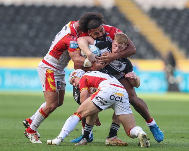 Harvey Barron of Hull FC is tackled by Ben Garcia of Catalan Dragons, Chris Satae of Catalan Dragons and Theo Fages of Catalan Dragons during the Betfred Super League Round 27 match Hull FC vs Catalans Dragons at MKM Stadium, Hull, United Kingdom, 21st September 2024

(Photo by Alfie Cosgrove/News Images)