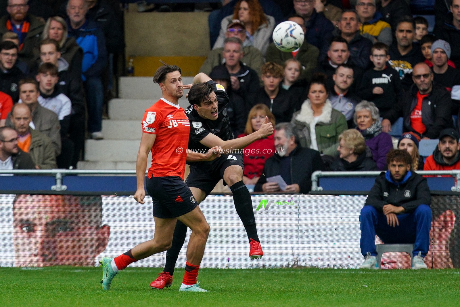 Jacob Greaves #4 of Hull City battles Harry Cornick #7 of Luton Town