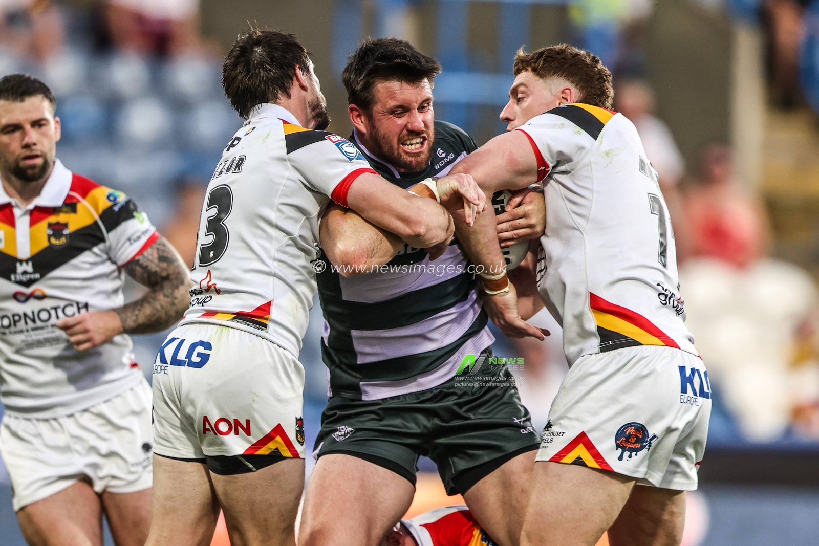 Joe Greenwood of Huddersfield Giants is tackled by Joe Mellor of Bradford Bulls and Dan Russell of Bradford Bulls during the Betfred Super League round 18 match Huddersfield Giants vs Bradford Bulls at Accu Stadium, Huddersfield, United Kingdom on 10 July 2026

(Photo by Alfie Cosgrove/News Images)