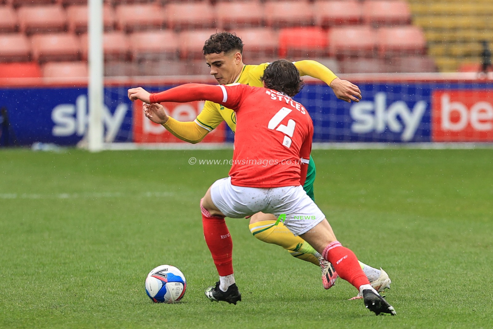 Max Aarons #2 of Norwich City and Callum Styles #4 of Barnsley dual for the ball