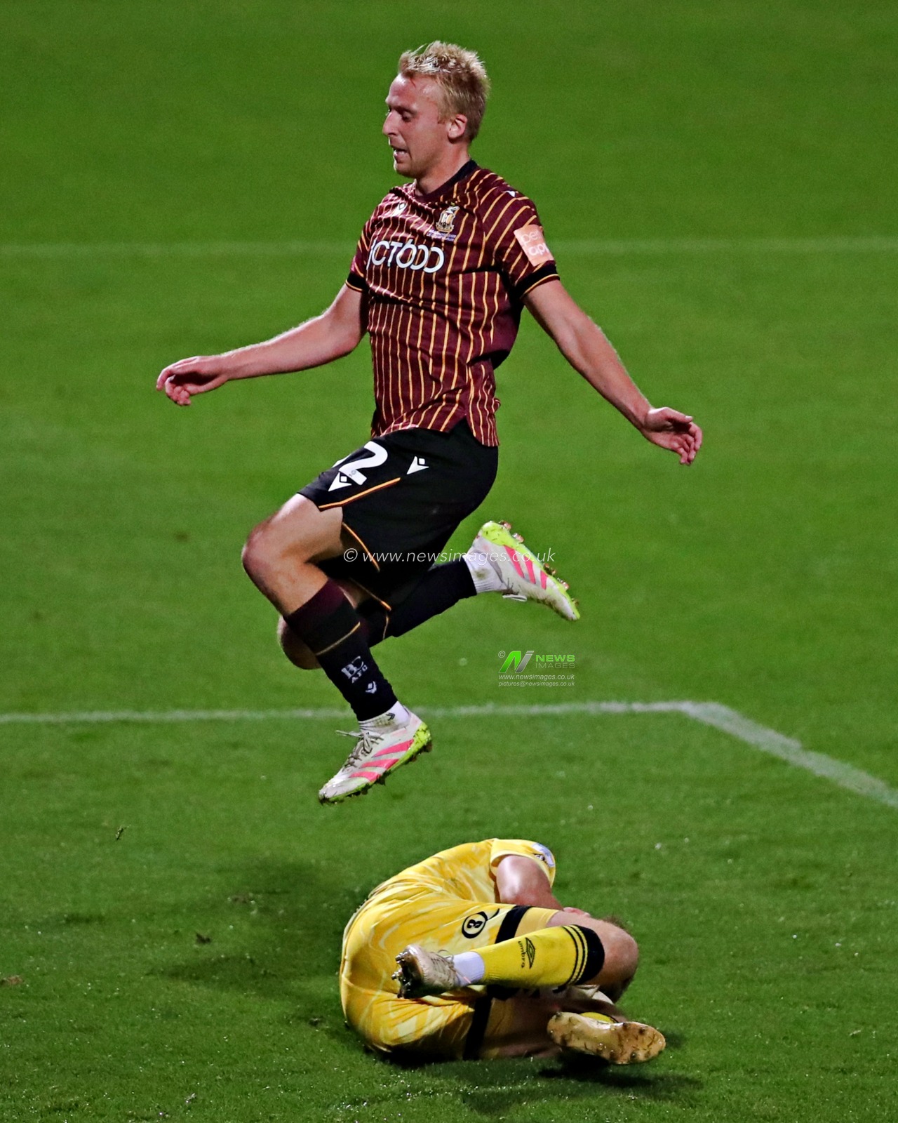 Bobby Pointon of Bradford City jumps over Seb Auton of Grimsby Town during The Vertu Trophy match Bradford City vs Grimsby Town at University of Bradford Stadium, Bradford, United Kingdom, 2nd September 2025(Photo by Sam Eaden/News Images)