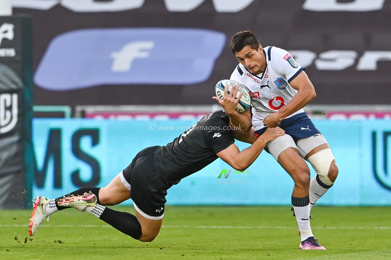 Harold Vorster of Vodacom Bulls is tackled by Owen Watkin of Ospreys