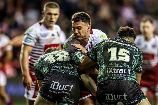Kaide Ellis of Wigan Warriors is tackled by Bailey Hodgson of Leigh Leopards and Jacob Alick-Wiencke of Leigh Leopards during the Betfred Super League match Wigan Warriors vs Leigh Leopards at The Brick Community Stadium, Wigan, United Kingdom on 26 February 2026

(Photo by Alfie Cosgrove/News Images)