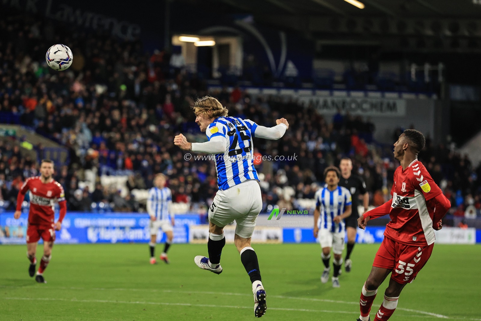 Danny Ward #25 of Huddersfield Town heads on goal, saved