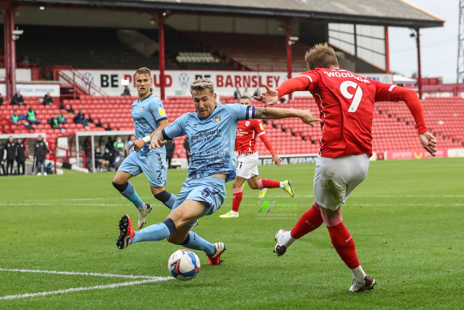 Cauley Woodrow (9) of Barnsley shoots just wide of goal as Kyle McFadzean (5) of Coventry City slides in to block