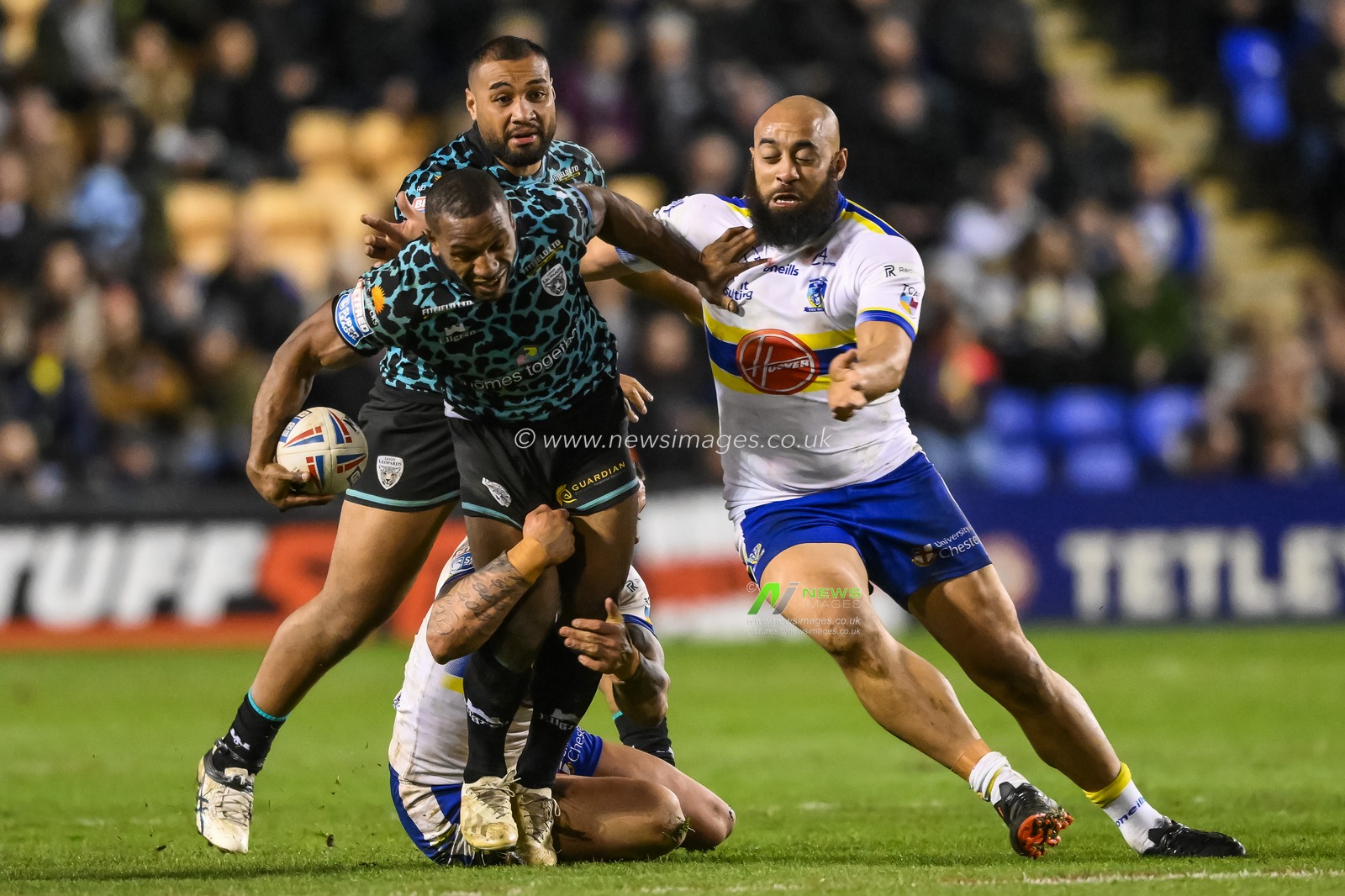 Edwin Ipape #9 of Leigh Leopards is tackled by Paul Vaughan #10 and Sam Kasiano #14 of Warrington Wolves  during the Betfred Super League Round 5 match Warrington Wolves vs Leigh Leopards at Halliwell Jones Stadium, Warrington, United Kingdom, 17th March 2023

(Photo by Craig Thomas/News Images)