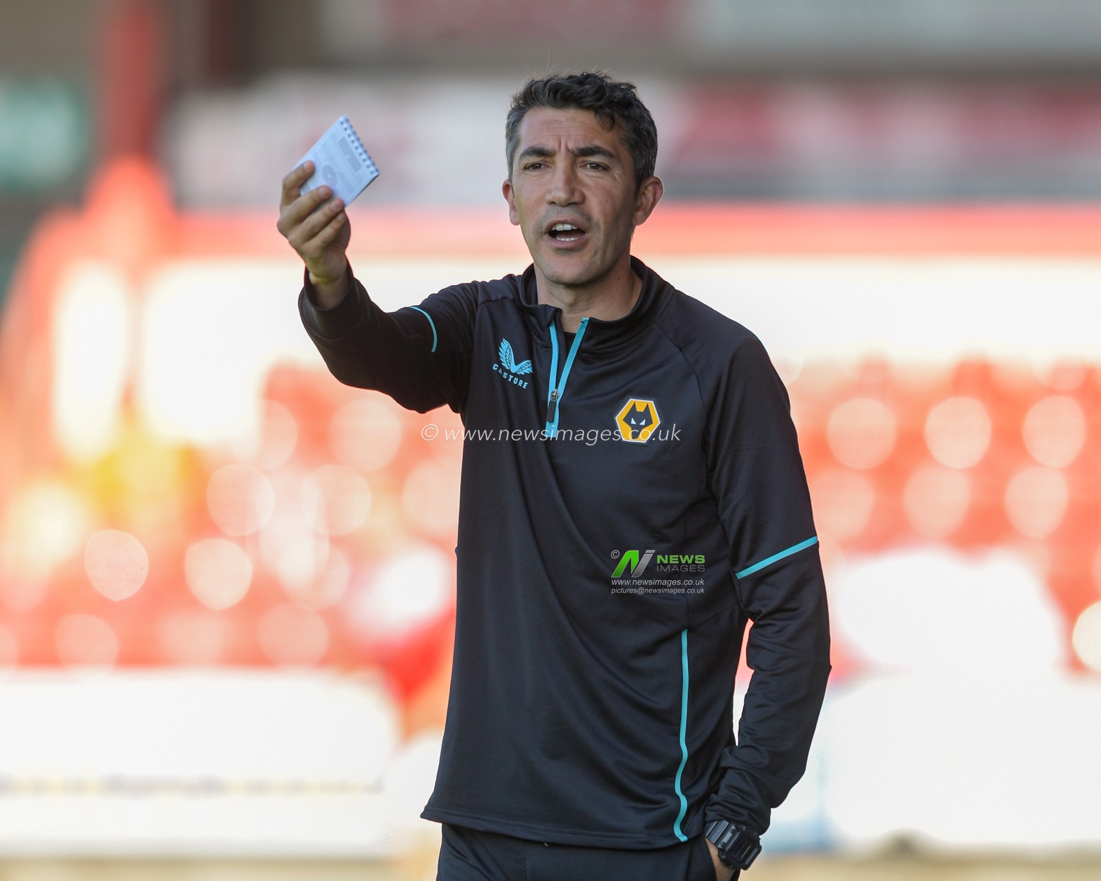 Bruno Lage manager of Wolverhampton Wanderers waves his notebook during the game