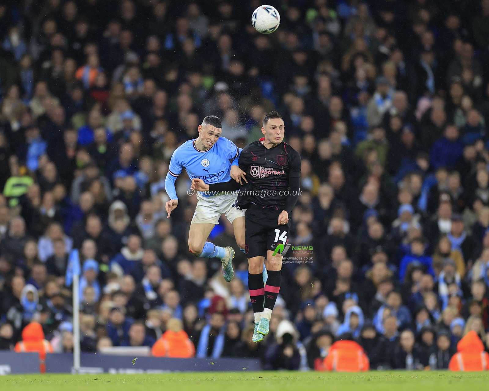 Phil Foden #47 of Manchester City  and Connor Roberts #14 of Burnley challenge for the header during the Emirates FA Cup Quarter Final match Manchester City vs Burnley at Etihad Stadium, Manchester, United Kingdom, 18th March 2023

(Photo by Conor Molloy/News Images)