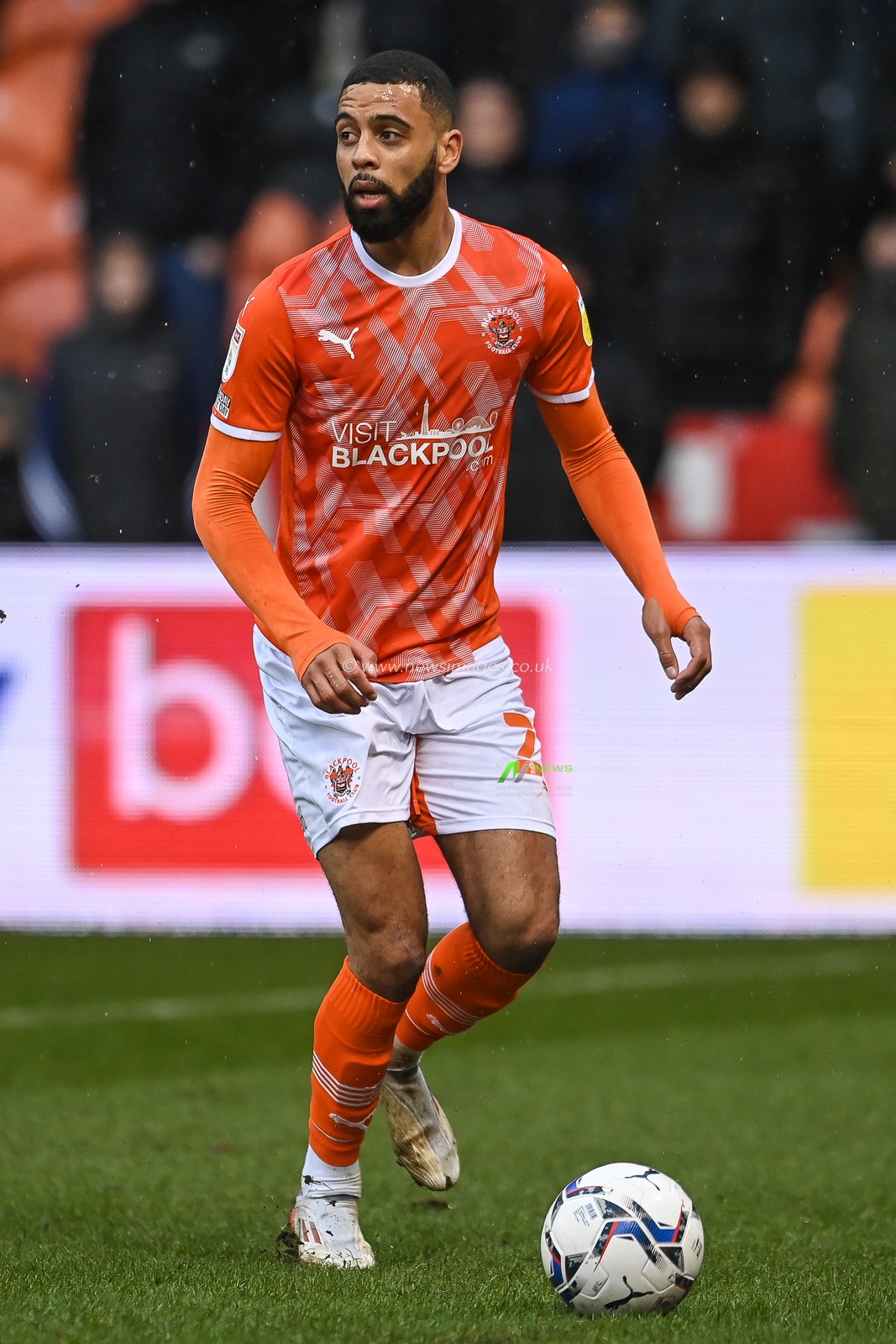 CJ Hamilton #22 of Blackpool makes a break with the ball