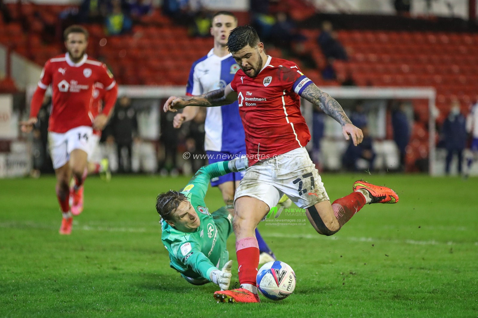 Alex Mowatt #27 of Barnsley skips past Thomas Kaminski #1 of Blackburn Rovers to score and make it 2-0