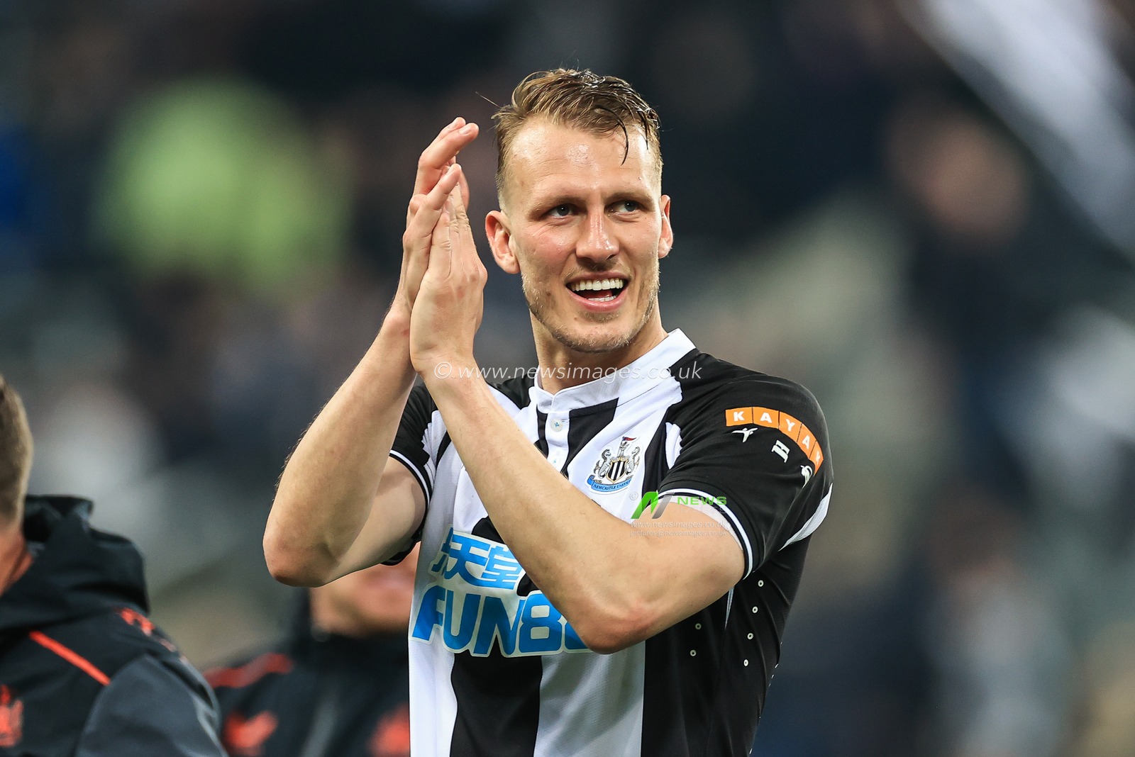 Dan Burn #33 of Newcastle United applauds the fans at the end of the game