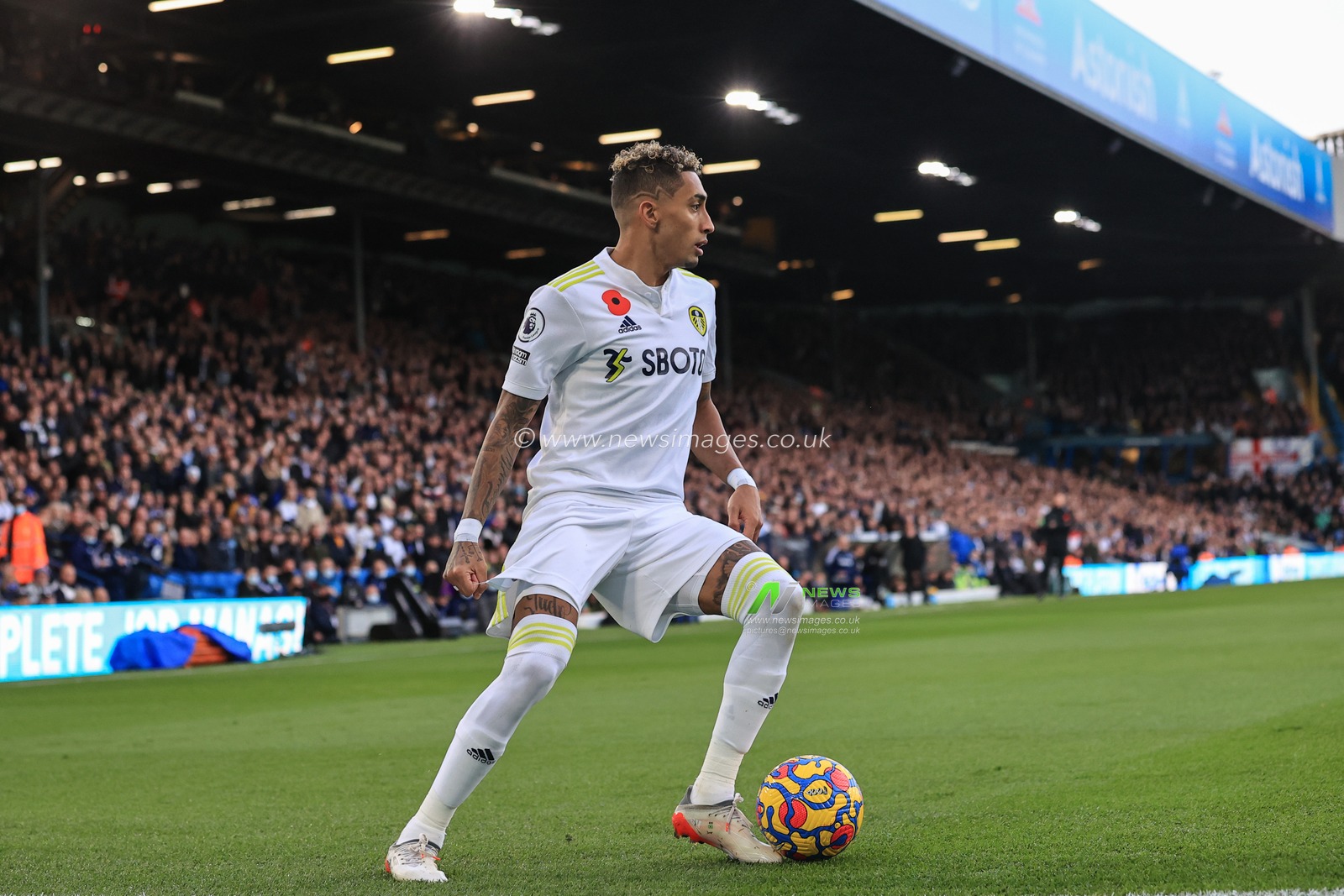 Raphinha #10 of Leeds United hold the ball on the edge of the area