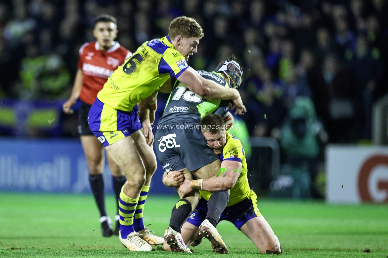 Paul SÃ©guier of Catalan Dragons is tackled by Dan Russell of Warrington Wolves and Luke Yates of Warrington Wolves during the Betfred Super League Round 2 match Warrington Wolves vs Catalans Dragons at Luke Littler Stadium, Warrington, United Kingdom, 21st February 2025

(Photo by Mark Cosgrove/News Images)