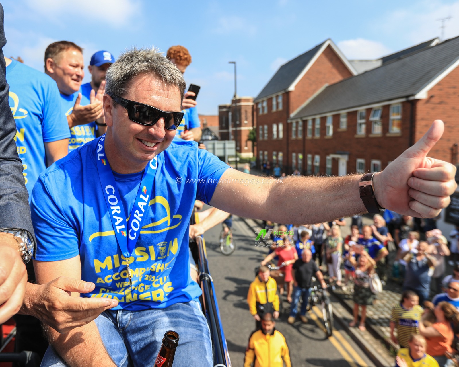 26th August 2019 , Open Top Bus, Town Hall, ,Warrington England ; 2019 Coral Challenge Cup Final open top bus tour and Town Hall celebrations ; Steve Price head coach of Warrington Wolves waves to the crowds on their way to Warrington Town Hall 

Credit: Mark Cosgrove/News Images