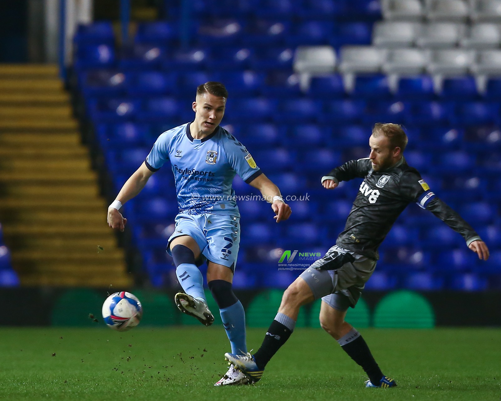 Leo Ostigard #2 of Coventry City passes the ball whilst under pressure from Barry Bannan #10 of Sheffield Wednesday