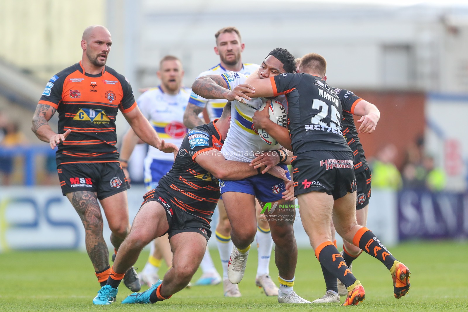 Tom Mikaele #18 of Warrington Wolves is tackled by Brad Martin #25 of Castleford Tigers after the Betfred Super League Round 24 match Warrington Wolves vs Castleford Tigers at Halliwell Jones Stadium, Warrington, United Kingdom, 2nd September 2023

(Photo by Gareth Evans/News Images)