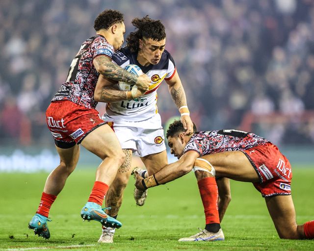 Charlie Staines of Catalans Dragons is tackled by Liam Horne of Leigh Leopards and Adam Cook of Leigh Leopards during the Betfred Super League match Leigh Leopards vs Catalans Dragons at Leigh Sports Village, Leigh, United Kingdom on 06 March 2026

(Photo by Alfie Cosgrove/News Images)