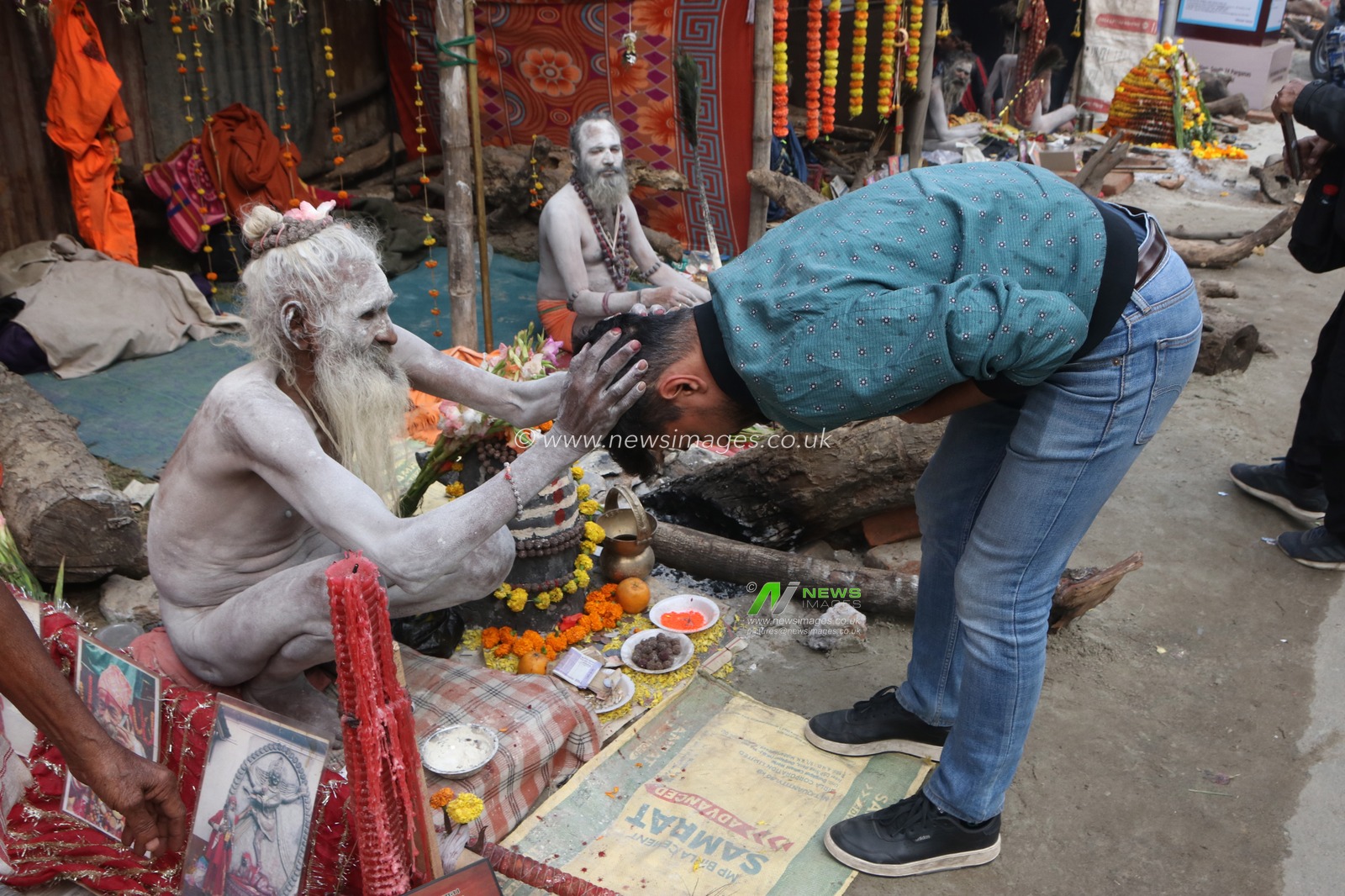 A Naga saint is giving his blessings to pilgrims at a transit camp of the Gangasagar fair in Kolkata, India, on January 9, 2025. The Gangasagar Mela is an annual Hindu festival held at Gangasagar, West Bengal, where the Ganges River meets the Bay of Bengal. The fair takes place at Kapilmuni's ashram on Gangasagar every year on Makar Sankranti.Pictures by Debajyoti Chakraborty.(Photo: Debajyoti Chakraborty/News Images)
