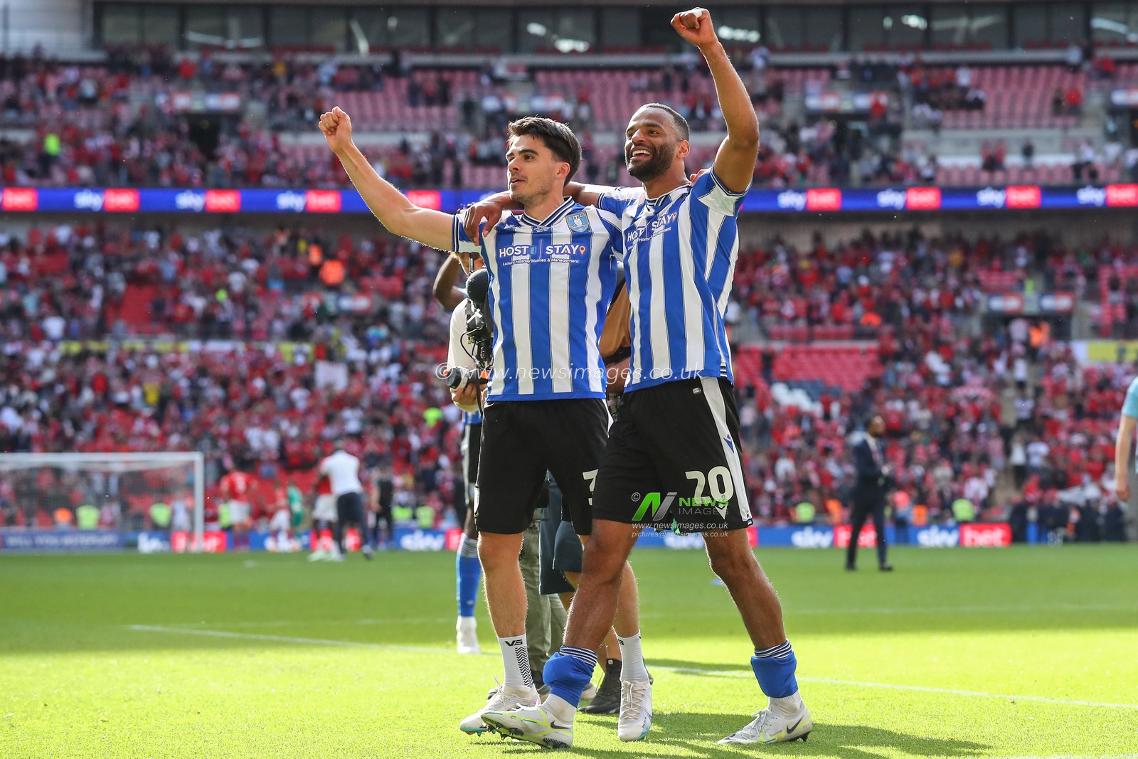 Jack Hunt #32 of Sheffield Wednesday & Michael Ihiekwe #20 of Sheffield Wednesday celebrate their win and promotion to the Championship after the Sky Bet League 1 Play-off Final match Barnsley vs Sheffield Wednesday at Wembley Stadium, London, United Kingdom, 29th May 2023

(Photo by Gareth Evans/News Images)
