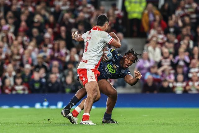 Junior Nsemba of Wigan Warriors evades a tackle form Peta Hiku of Hull KR during the 2025 Betfred Super League Grand Final Hull KR v Wigan Warriors at Old Trafford, Manchester, United Kingdom, 11th October 2025

(Photo by Alfie Cosgrove/News Images)