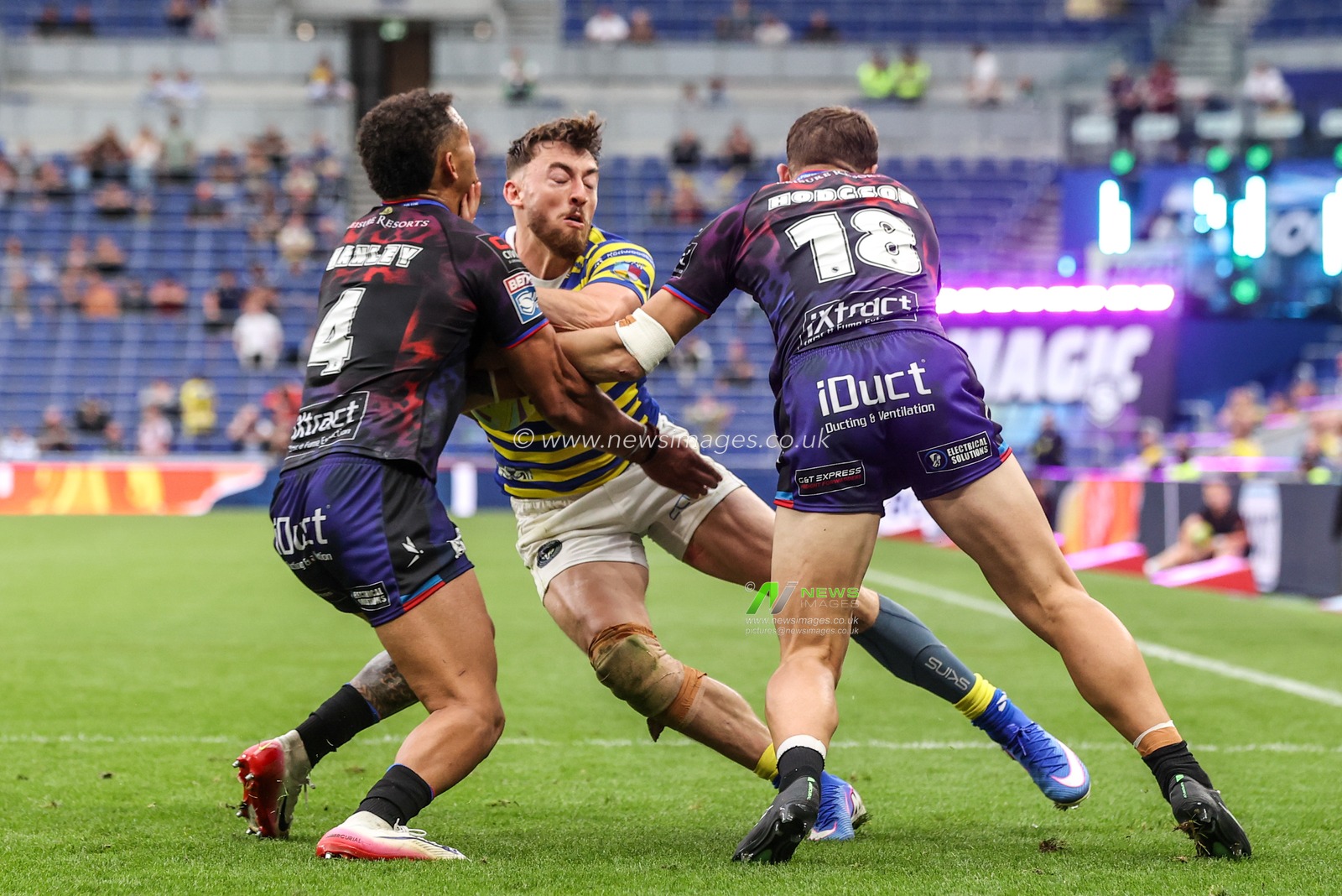 Matty Ashton of Warrington Wolves is tackled by Umyla Hanley of Leigh Leopards and Bailey Hodgson of Leigh Leopards during the Betfred Super League Magic Weekend match Leigh Leopards vs Warrington Wolves at Leigh Sports Village, Leigh, United Kingdom on 04 July 2026

(Photo by Alfie Cosgrove/News Images)