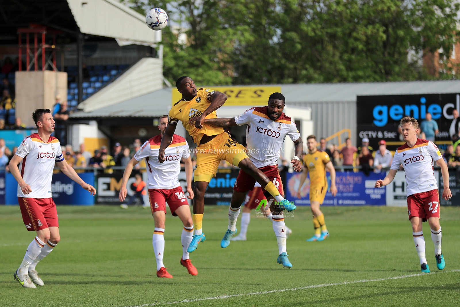 Isaac Olaofe #16 of Sutton United and Yann Songo'o #6 of Bradford City contest a header.